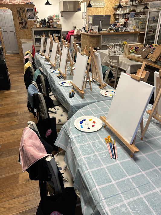Paint and sip night at the start with blank canvases on the table, at a tea room